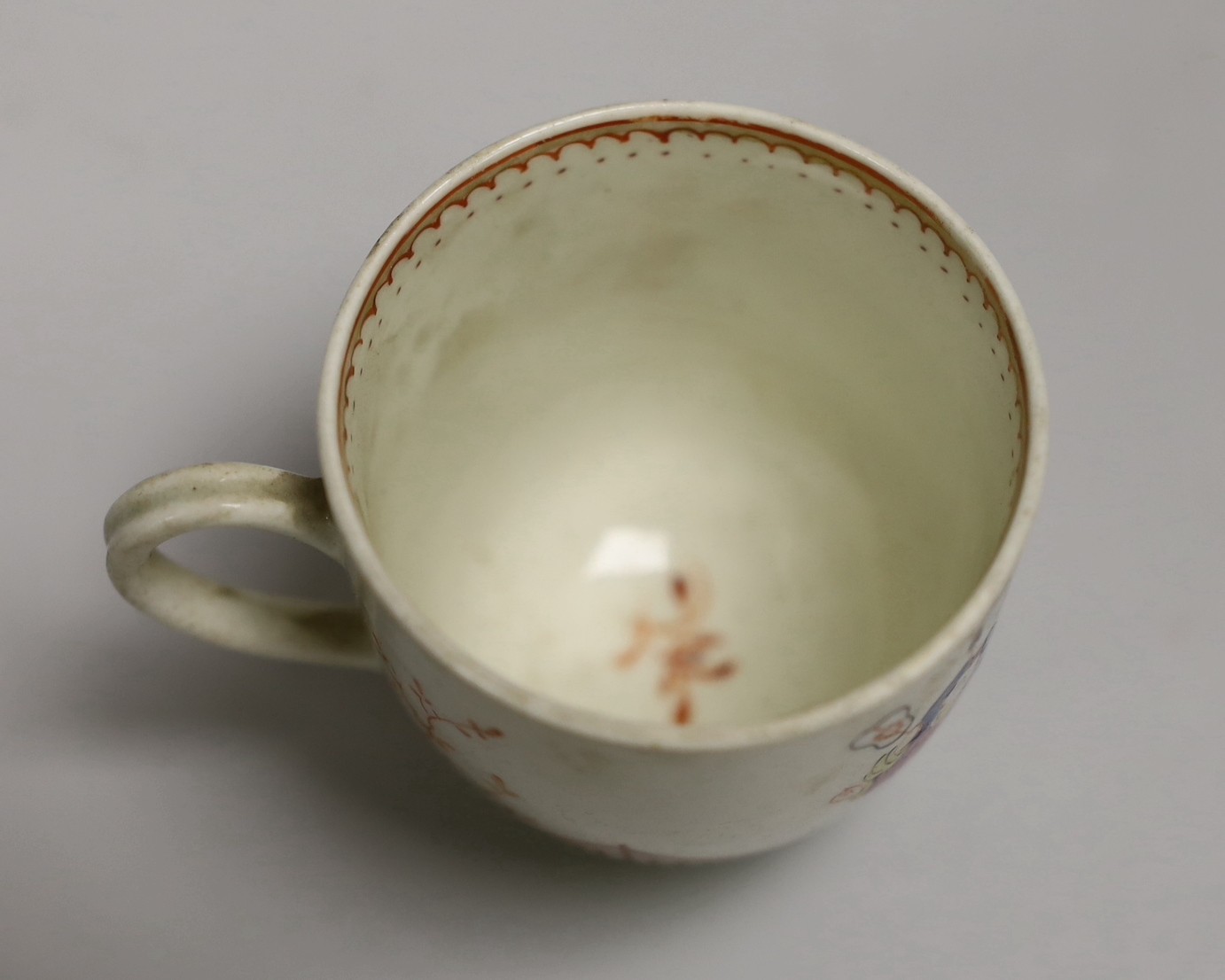 An 18th century Worcester porcelain coffee cup, a later saucer and a Chinese saucer, cup 6.5cms high